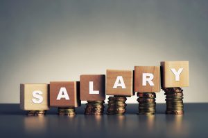 Salary,Text,Written,On,Wooden,Block,With,Stacked,Coins,On